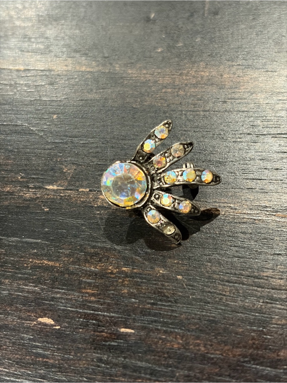 Small AJC brooch with iridescent stones